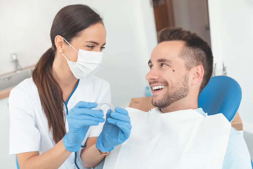 Dentist-shows-invisible-braces-aligner