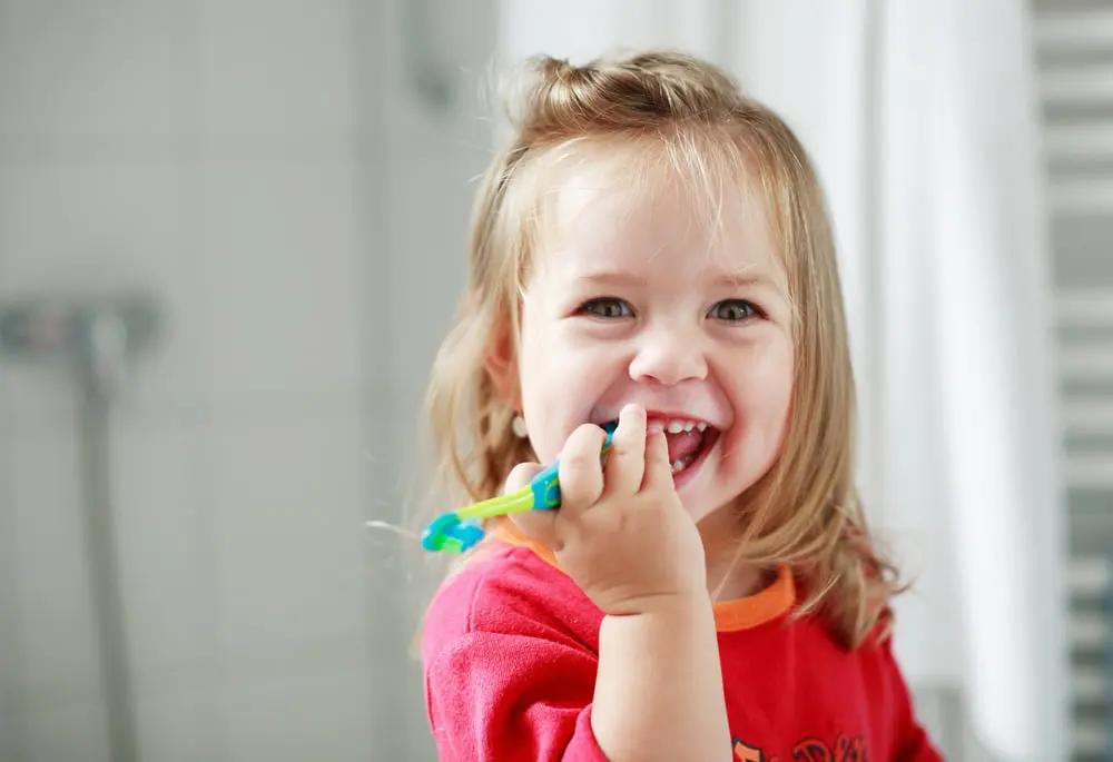 Small girl washing her teeth