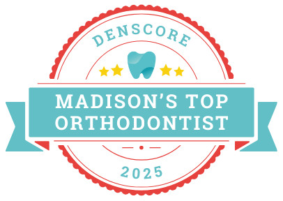 Badge reading "Denscore: Madison's Top Orthodontist 2025" with a tooth icon and stars, surrounded by a red border and ribbons.