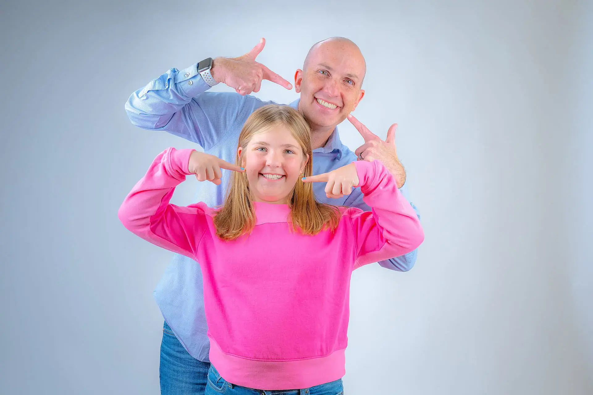 Dr. Adam Reynolds and a smiling girl proudly point to their Traditional Metal Braces, showcasing their smiles with Orthodontic Design Co. Orthodontics in Madison and Huntsville, AL, against a simple light background. Dr. Adam Reynolds and a smiling girl proudly point to their Traditional Metal Braces, showcasing their smiles with Orthodontic Design Co. Orthodontics in Madison and Huntsville, AL, against a simple light background.