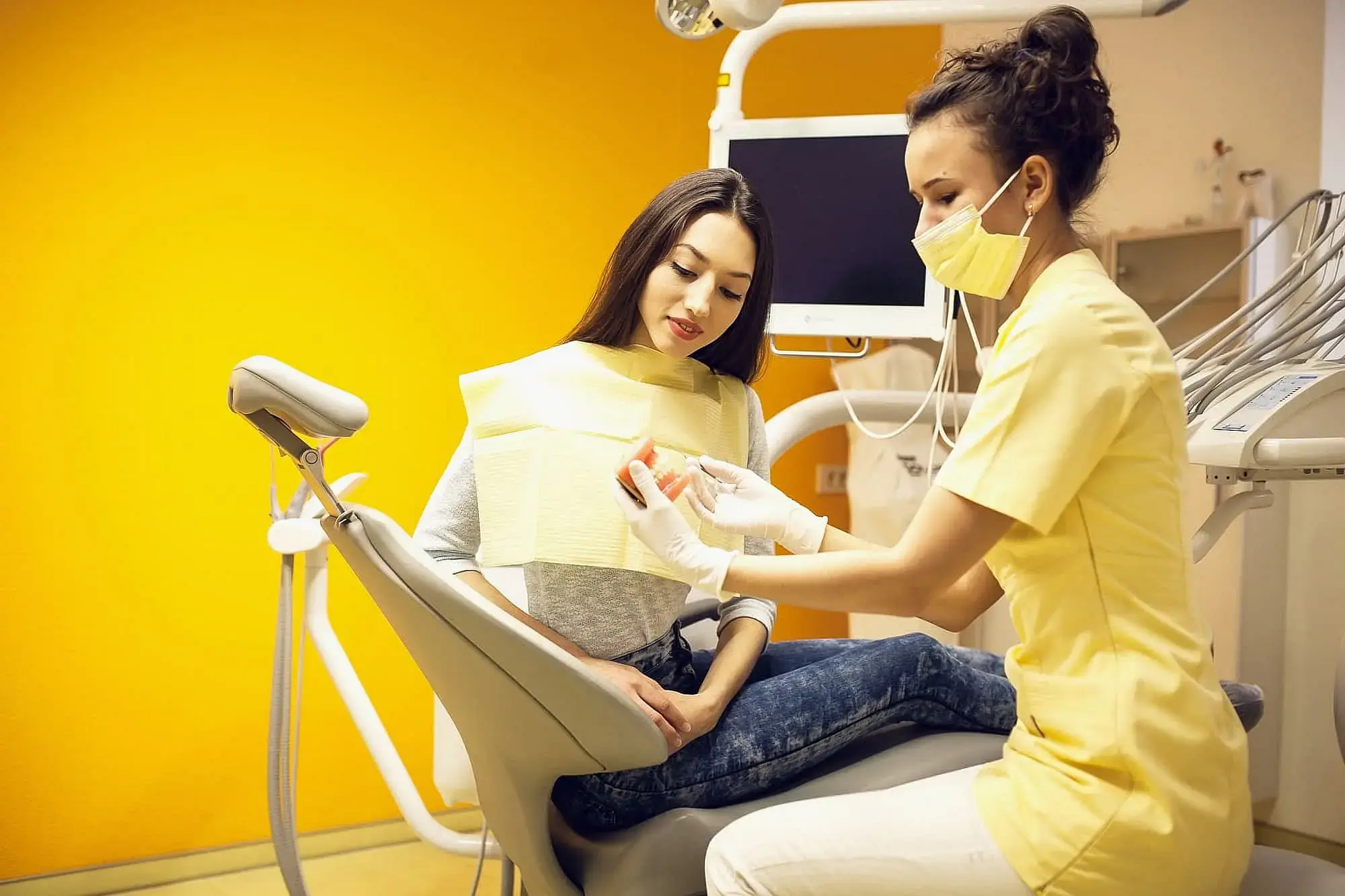 In a yellow-walled clinic, a dentist explain about orthodontic insurance plans to patient at Orthodontic Design Company in Madison and Huntsville, AL. In a yellow-walled clinic, a dentist explain about orthodontic insurance plans to patient at Orthodontic Design Company in Madison and Huntsville, AL.