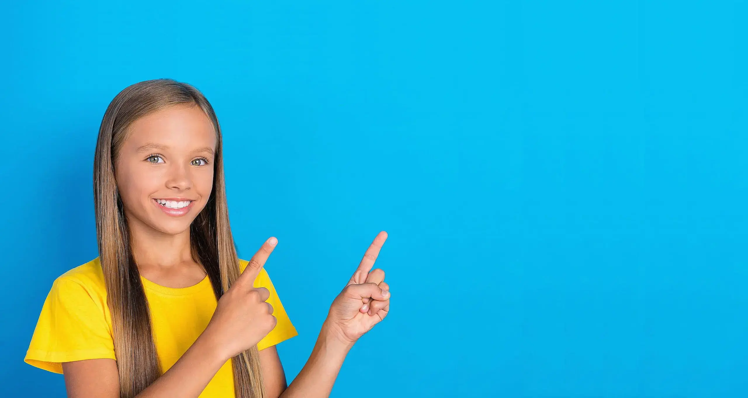 A smiling girl with long straight hair and a yellow shirt points up to the right against a blue background, promoting orthodontic insurance plans available at Orthodontic Design Co. in Madison and Huntsville, AL. A smiling girl with long straight hair and a yellow shirt points up to the right against a blue background, promoting orthodontic insurance plans available at Orthodontic Design Co. in Madison and Huntsville, AL.