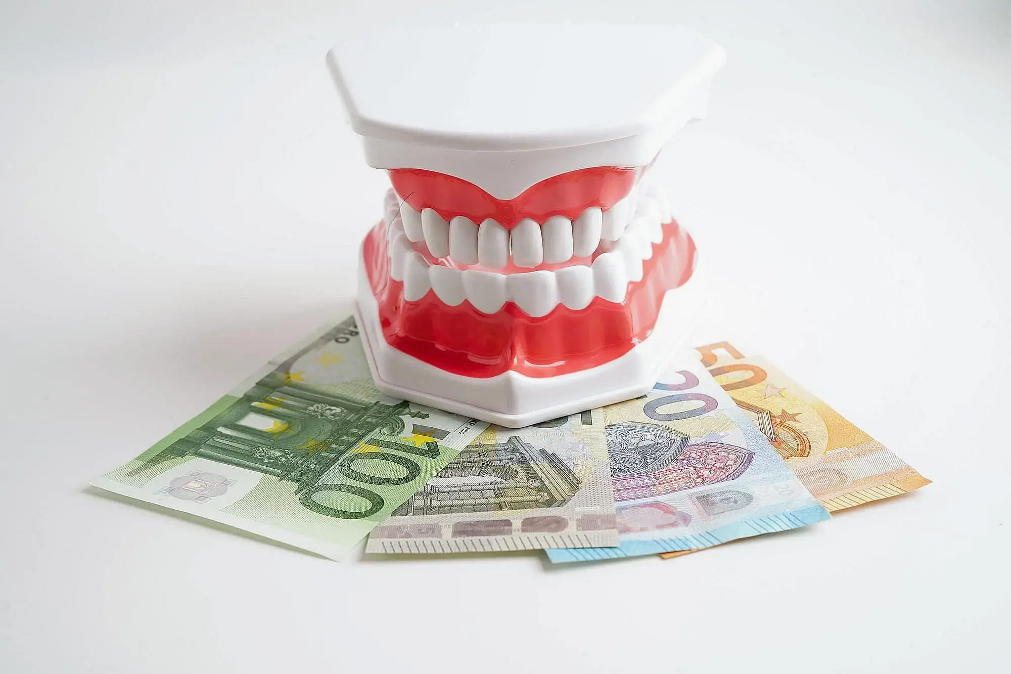 A plastic teeth model rests on euro bills represent orthodontic insurance plans for Orthodontic Design Company in Madison and Huntsville, AL. A plastic teeth model rests on euro bills represent orthodontic insurance plans for Orthodontic Design Company in Madison and Huntsville, AL.