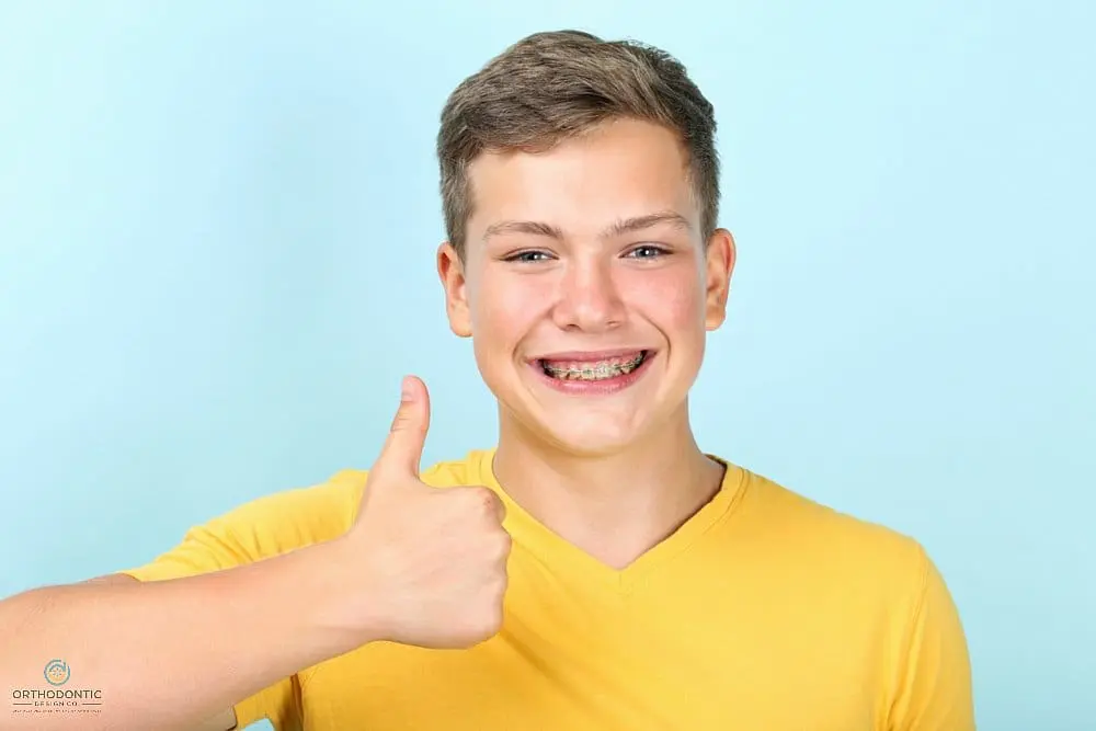 Man with braces showing thumbs up